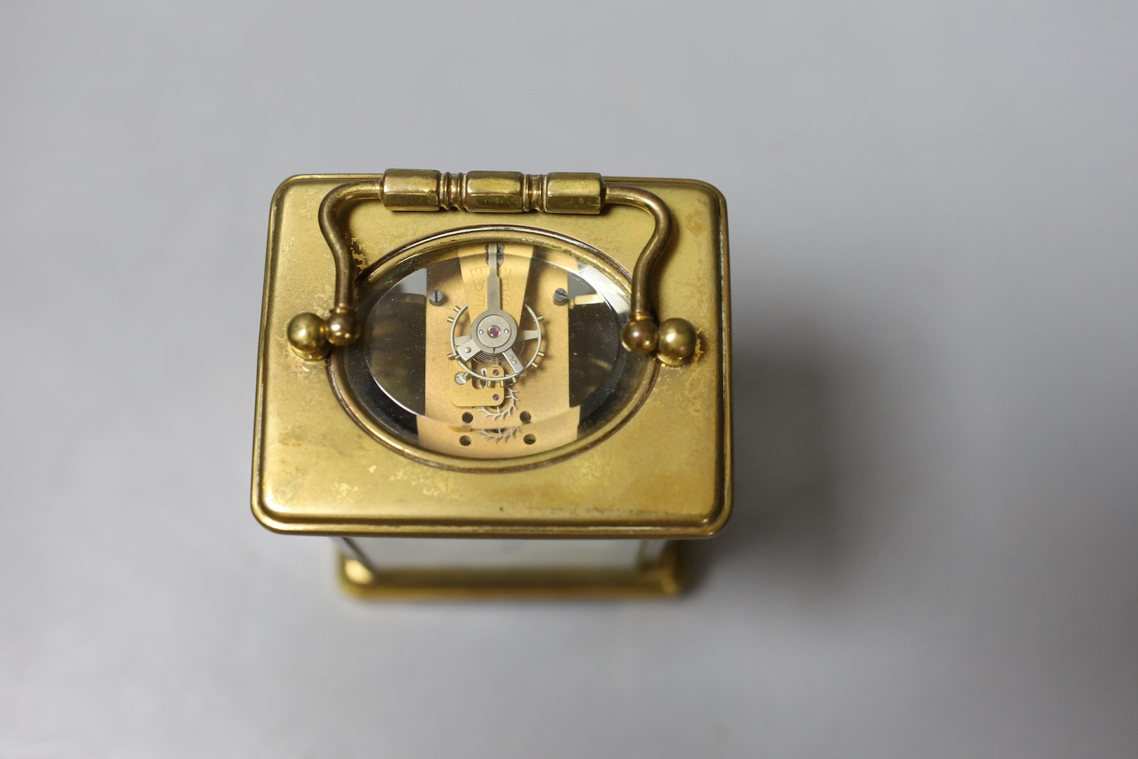 A brass carriage timepiece, retailed by J. Moser & co. in leather case with key.